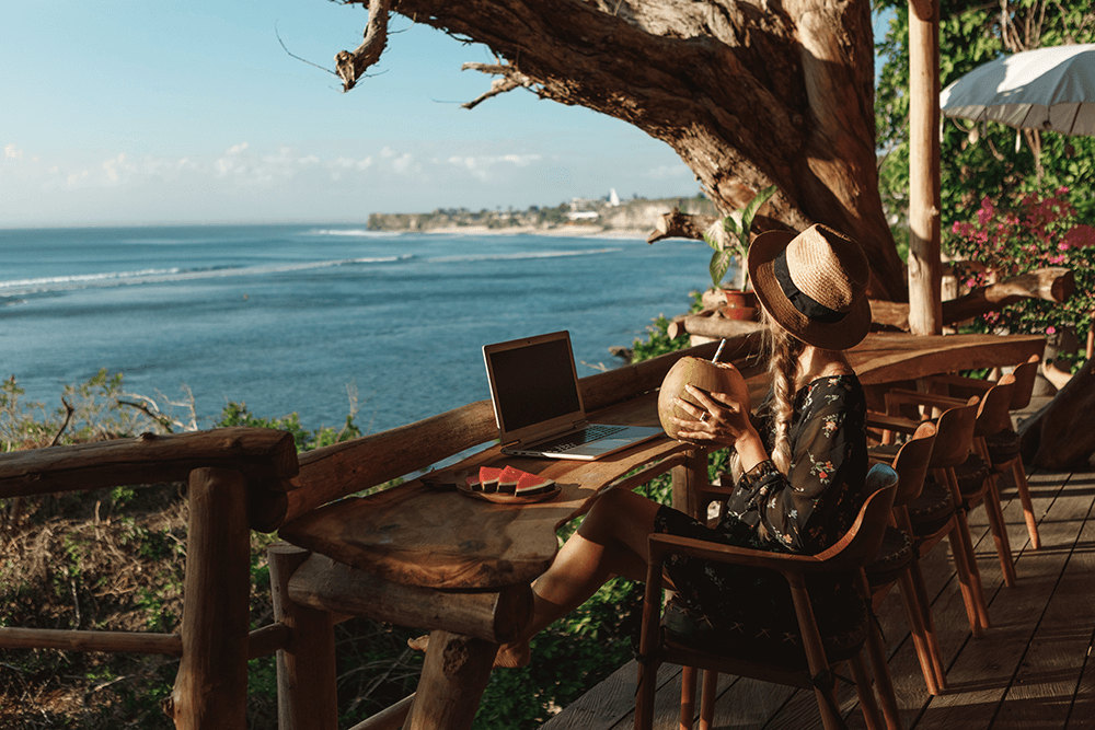 digital nomad by sea on laptop